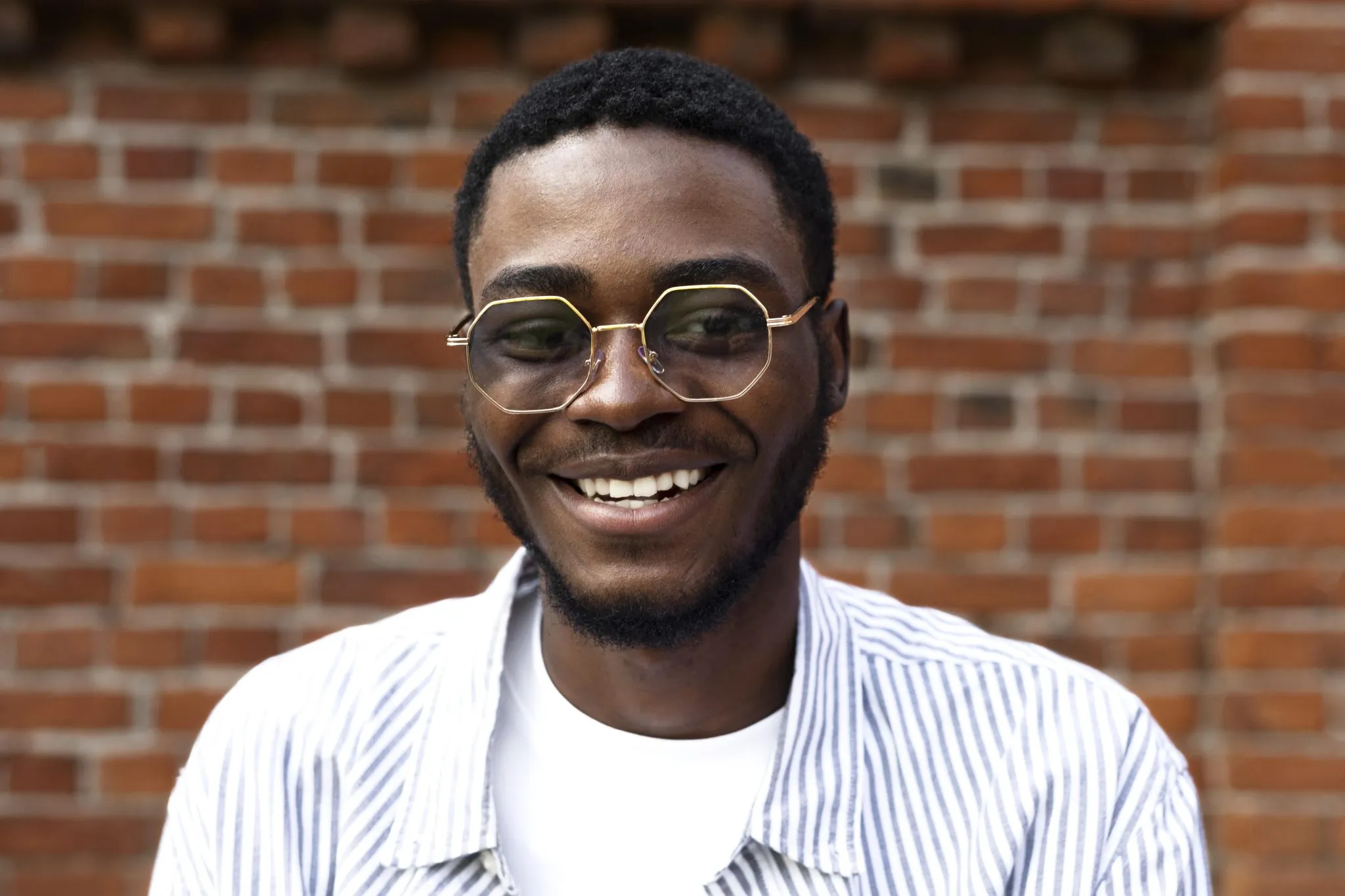 Close-up portrait of a smiling patient wearing prescription glasses