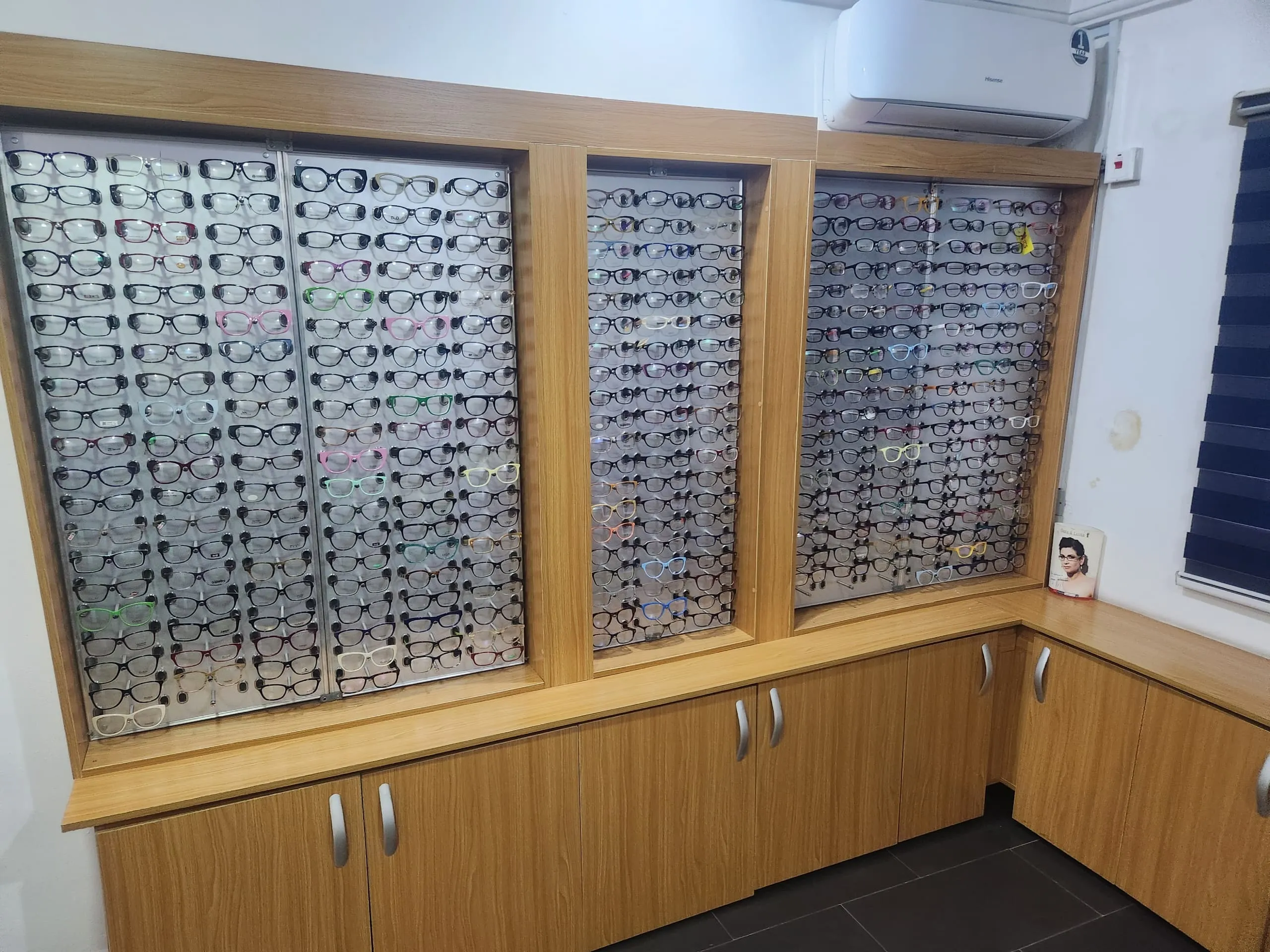 A wide view of the fully stocked eyewear frame wall at Locus Eye Clinic
